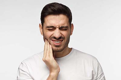 Dental Injury Treatment man in pain and in need of Dental Injury Treatment