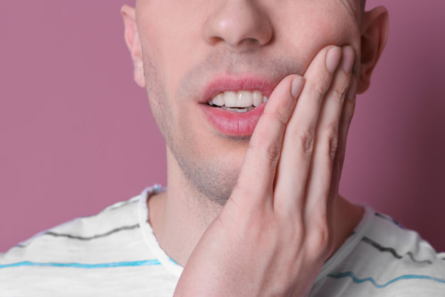 a man looking for ways on how does tooth decay develop
