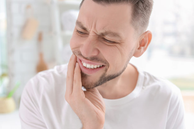 a man experiencing common dental problems