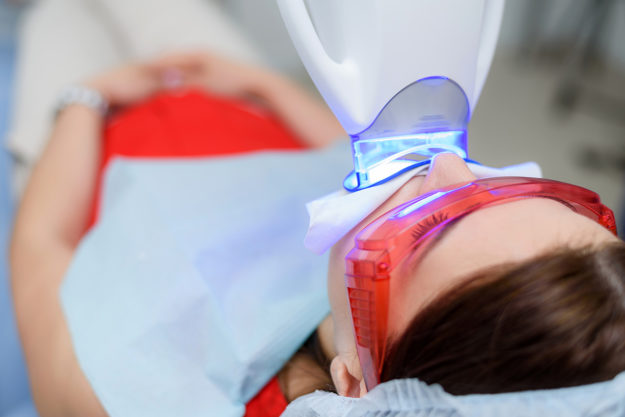 a woman getting work done after seeing teeth whitening options