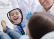 a child smiles because a dentist fixed his pediatric dental emergency