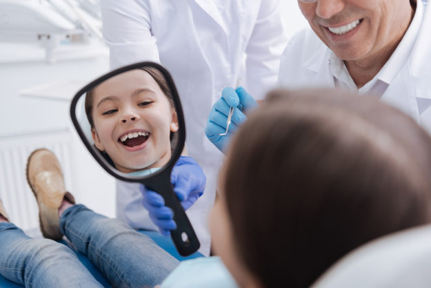 Fixing a Pediatric Dental Emergency a child smiles because a dentist fixed his pediatric dental emergency