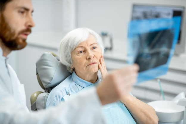 a patient asking a dentist about dental health services