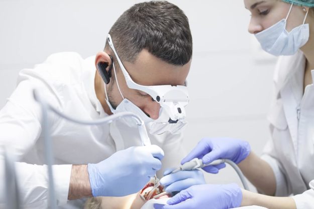 a doctor performing dental implant surgery
