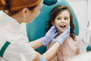 girl learning about pediatric dentistry