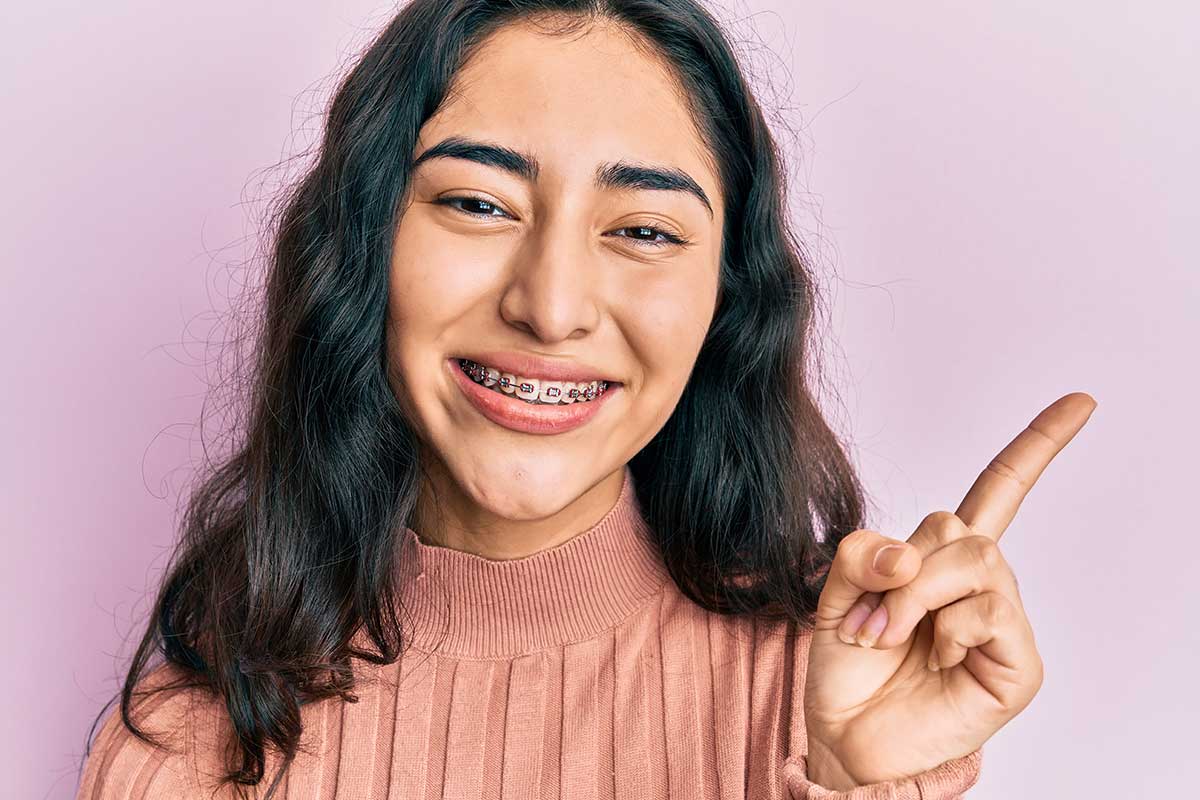 3 Benefits of Braces for Kids (1) girls shows off her braces